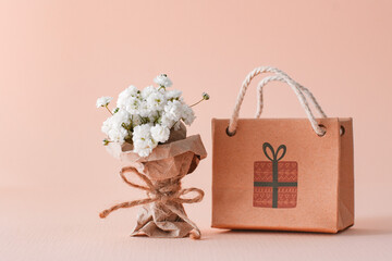 mini bouquet gypsophila craft wrapper paper gift bag. concept congratulations holiday women day...