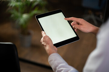  Close up of man using digital tablet.