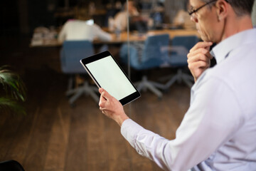  Close up of man using digital tablet.