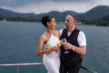 Romantic couple in love have fun sailing in the sea standing on yacht deck enjoy amazing view