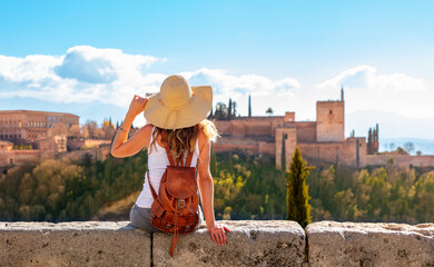 Tourism at Granada- Andalusia in Spain- Woman looking at Alhambra - obrazy, fototapety, plakaty