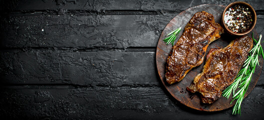 Grilled beef steaks with spices and herbs.