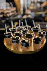 Sweet luxury candy bar on table in restaurant in black tone. Cakes and other sweets