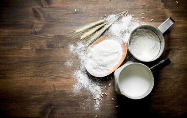 Flour with milk in a jug and spikelets.