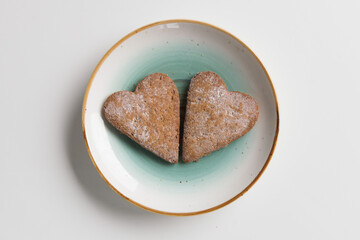 heart shaped cookies on blue plate on white background
