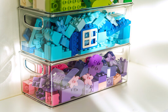 Lego duplo. LEGO blocks sorting by colors in transparent plastic containers. Storage Ideas in nursery. Space organizing at children's room.