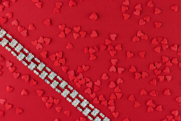 Beautiful diamond bracelet on a red monochromatic background, Valentine's Day 