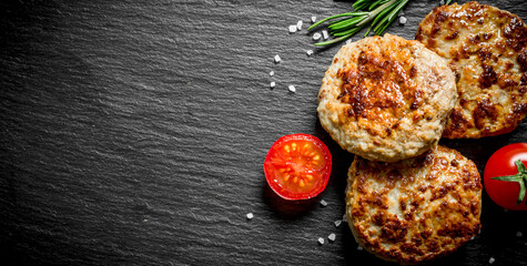 Cutlets with rosemary and tomatoes.