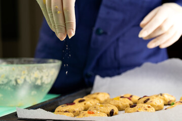 Oatmeal cookies with candied fruits on a baking sheet
