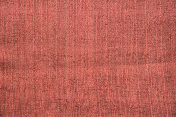 Brick red linen fabric texture closeup as textile background