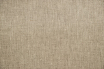 Natural color linen fabric texture closeup as textile background