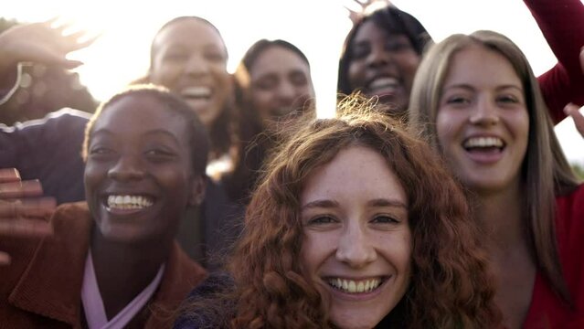 Multiethnic group of women friends having fun together greeting in video call with mobile phone - Diversity female authentic lifestyle concept