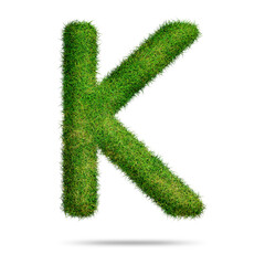 Green grass alphabet letter k for text or education concept
