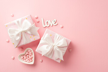 Valentine's Day concept. Top view photo of gift boxes with white ribbon bows heart shaped plate with sprinkles and inscription love on isolated pastel pink background