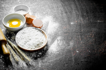 Baking background. Flour with spikeles and a rolling pin.