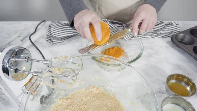 Step by step. Mixing ingredients in a mixing bowl to bake cranberry muffins.