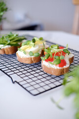 Healthy sandwiches with vegetables and microgreens.