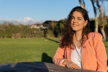 Business girl smiling in the park