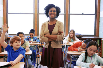 Portrait, student question and black woman teacher in classroom or middle school. Education, arms crossed or boy raising hand to answer questions, studying or learning help with happy female educator - obrazy, fototapety, plakaty