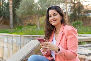 Young girl typing on her cell phone.