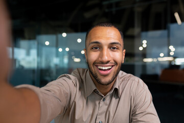 Video ringing, successful businessman looking at smartphone camera talking remotely with...