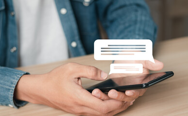 Man using smartphone to work from home. Conversation in the chat box icon that appears. social media concept.