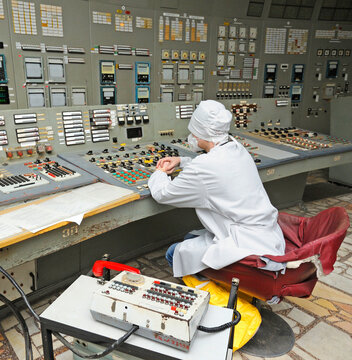 Man operator working at the main control board in control operations room of the reactor of the Chernobyl Nuclear Power Plant