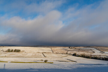 Snow shower clouds approach hills in Northumberland, UK