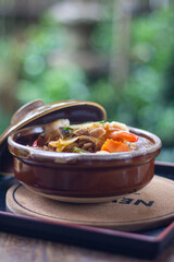 udon noodles kimchi pork shrimp in bowl and cup lid put on focus view