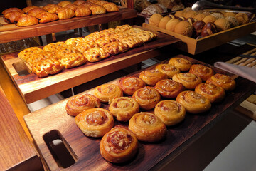 Various selection of pasty, sweet buns and cupcakes display on buffet table