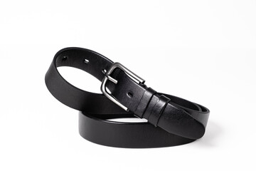 Black leather belt for trousers and jeans. Fastened fashionable men leather belt with dark chrome matted metal buckle isolated on white background. Male accessory. Luxury strap. Haberdashery goods