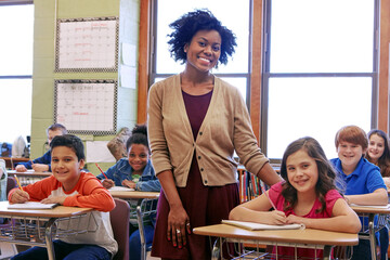 Education, learning and teacher in classroom with kids writing exam or test at Montessori school....
