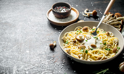 Pasta with mushrooms and sauce in a plate.