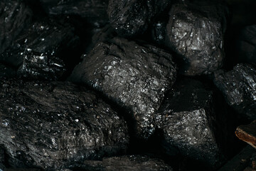 Black coal stones close-up. Solid advertising background..