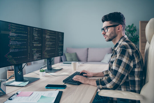 Photo of confident busy coder dressed eyewear typing application modern gadget indoors workplace workstation loft
