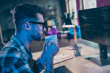 Profile photo of focused clever web designer sitting chair hands hold tea mug create edit open...
