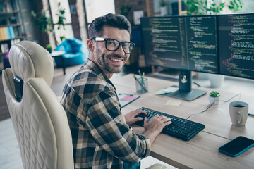 Profile photo of clever positive hardware expert man sitting chair keyboard typing create code open...