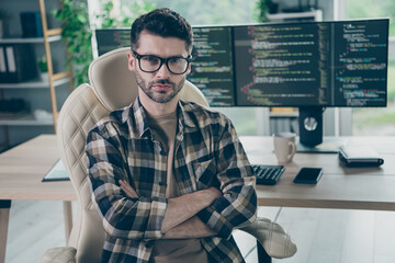 Photo of serious focused web designer guy sitting chair crossed arms database optimization workplace open space indoors