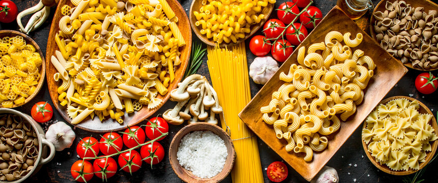 Different kinds of raw paste in bowls with garlic , mushrooms and cherry.