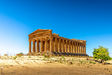 Agrigento, Sicily, Italy - July 12, 2020: Greek ruins of Concordia Temple in the Valley of Temples near Agrigento in Sicily - obrazy, fototapety, plakaty