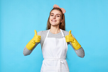 woman in rubber gloves and cleaner apron showing ok