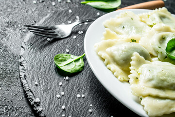 Ravioli with spinach leaves.