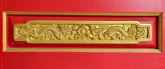 NONTHABURI, THAILAND - January 16, 2023 : Wooden door golden dragon at Dragon Temple Kammalawat or...