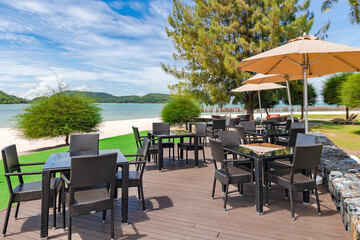 Outdoor cafe veranda with wicker furniture on Chenang beach on the Andaman Sea coast in Langkawi island, Malaysia