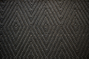 dark brown carpet texture shot from above.