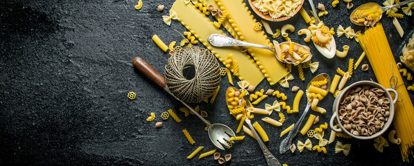 Different types of pasta dry the spoon and bowl.