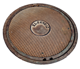 Round manhole lid covering an access point to electrical circuitry, transparent PNG.