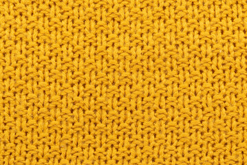 Fototapeta premium Texture or background of knitted yellow material. Knitting. Hobby