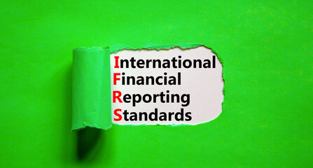 IFRS symbol. Concept words IFRS international financial reporting standards on white paper on beautiful green background. Business IFRS international financial reporting standards concept. Copy space.