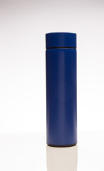 Aluminum blue bottle water placed on a wooden table in a restaurant or shop, Concept: Reduce plastic waste to recycle reusable and ecology nature, stainless glossy metal-containing liquid for sport